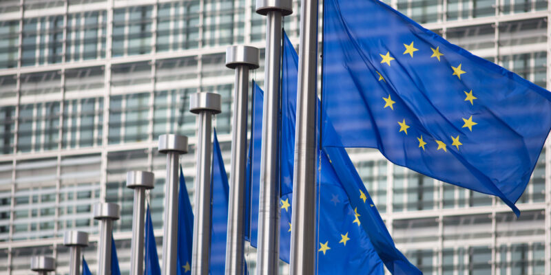 EU flags in front of European Commission building in Brussels