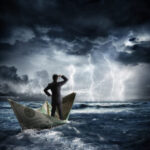 Man on a boat made of a 100 dollar bill in a storm
