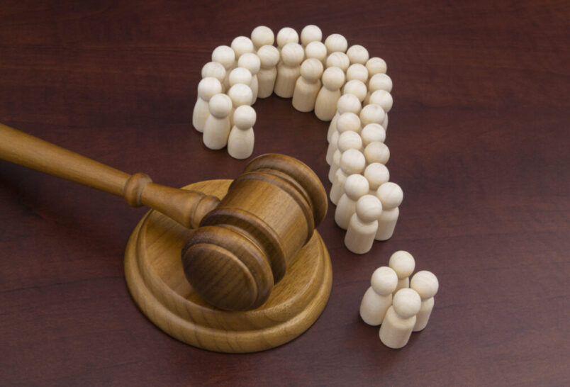 Gavel and question mark made out of pegs