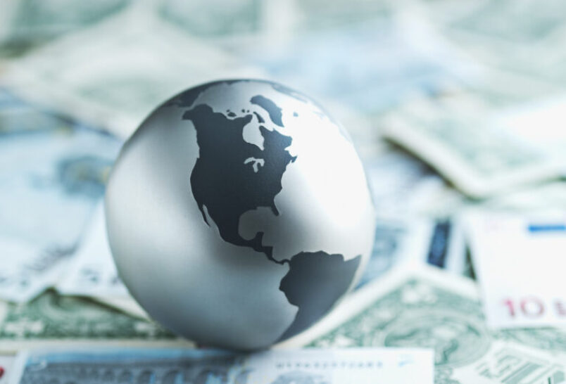 small globe on international money