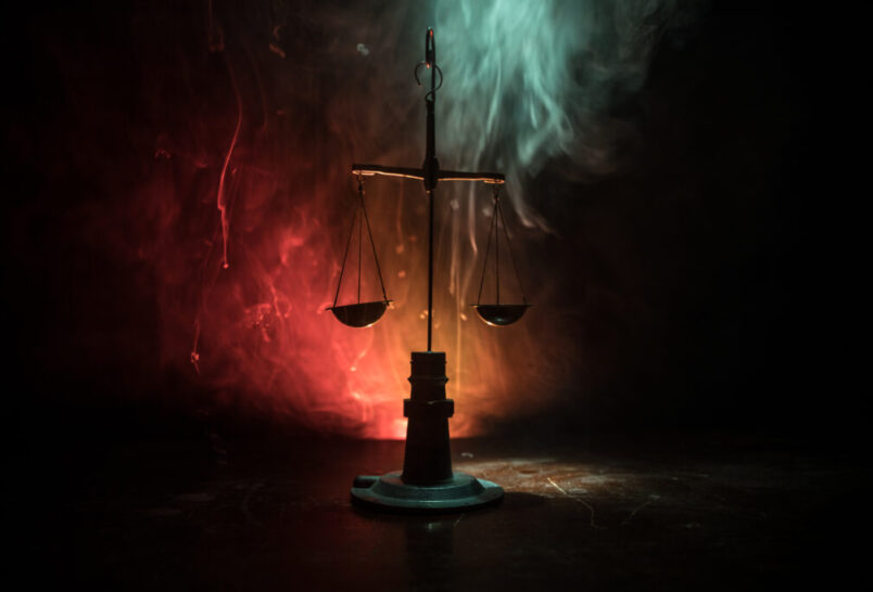 Justice scale with dark toned foggy background. Justice concept. Scale is symbol of justice