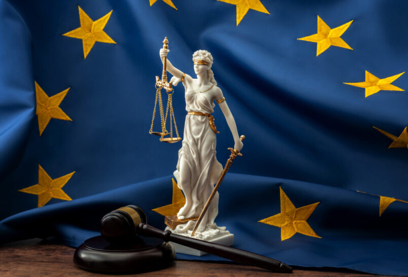 lady justice statue in front of eu flag
