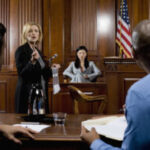 Courtroom with a lawyer talking and a person on the stand