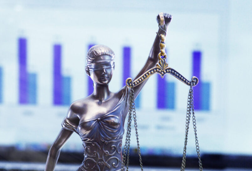 lady justice in front of a bar graph