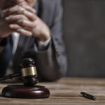 lawyer sitting at desk with a gavel and pen