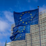 European Union flags waving at Berlaymont building of the European Commission in Brussels, Belgium