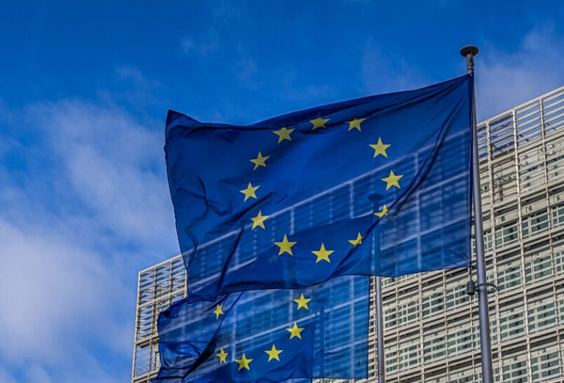 European Union flags waving at Berlaymont building of the European Commission in Brussels, Belgium